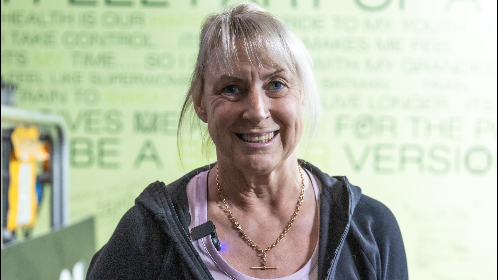 Nicole, a Genesis Ballarat member, smiling confidently in the gym reflecting her journey of overcoming physical challenges through tailored fitness programs.