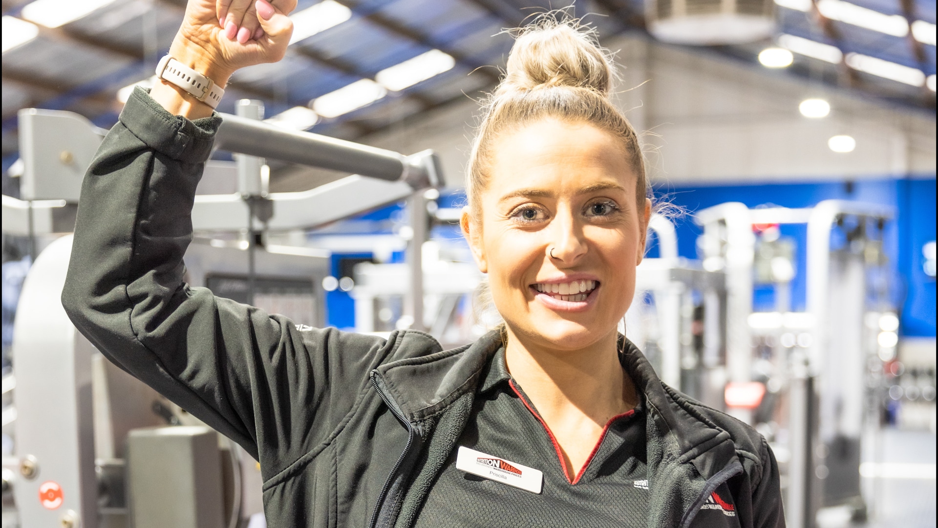Pricilla from Nutrition Warehouse smiling inside Genesis Ballarat gym, emphasising the benefits offered to members.